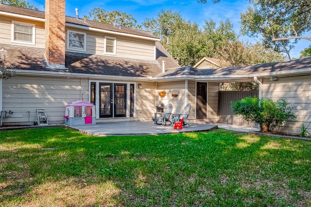 rear view of property with a lawn and a patio