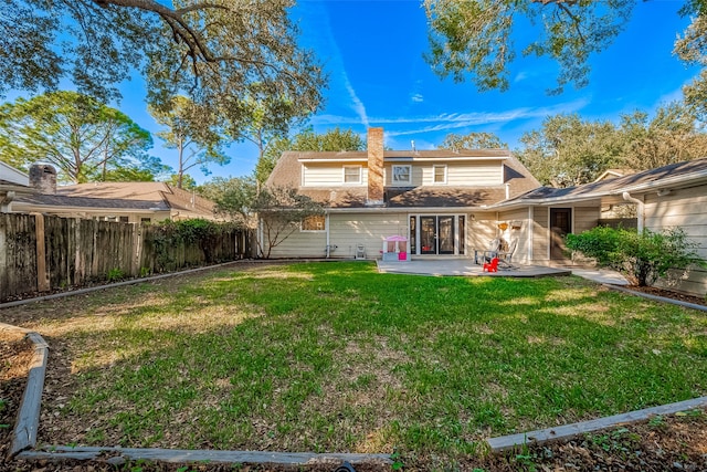 back of property featuring a lawn and a patio