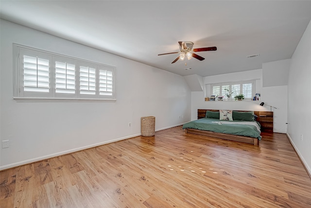 bedroom with light hardwood / wood-style floors and ceiling fan