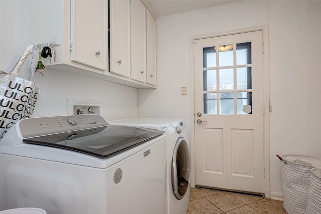 laundry area featuring light tile patterned flooring, cabinets, and separate washer and dryer