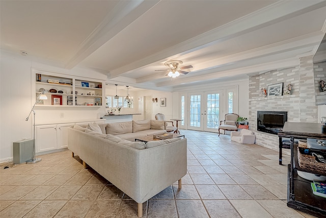 tiled living room featuring french doors, a brick fireplace, ceiling fan, ornamental molding, and beam ceiling