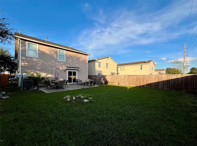 rear view of house with a patio area and a yard