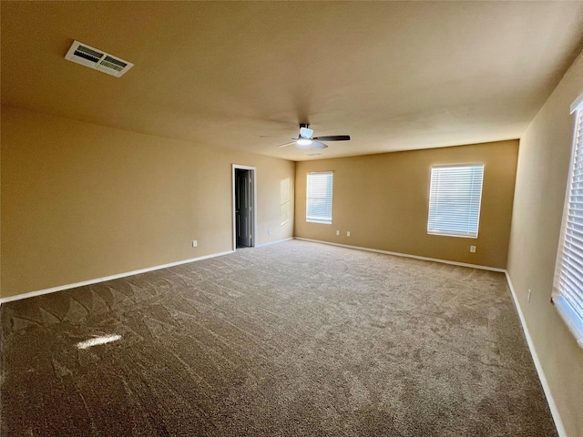 carpeted spare room with ceiling fan