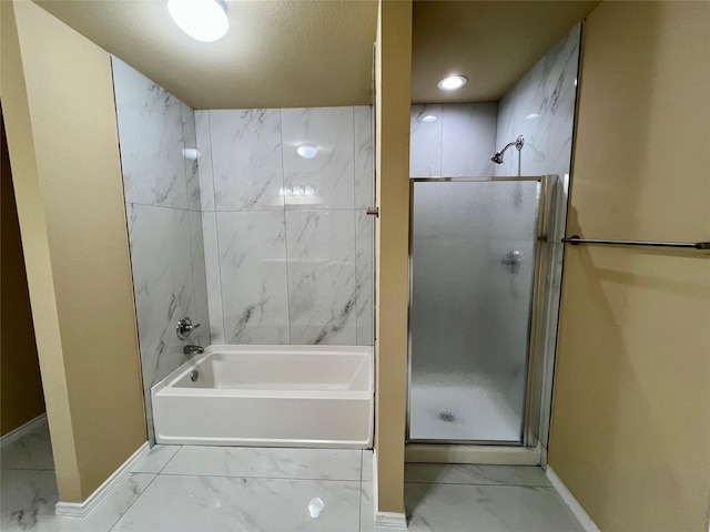 bathroom with a textured ceiling and independent shower and bath