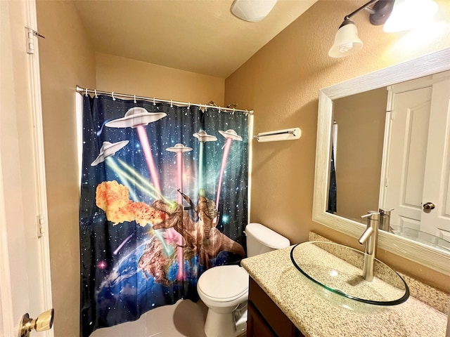 bathroom with vanity, a shower with shower curtain, and toilet