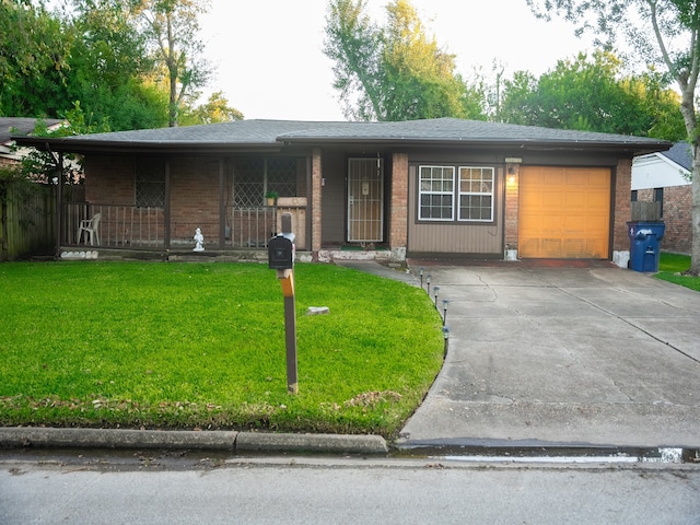 single story home featuring a front lawn, covered porch, and a garage