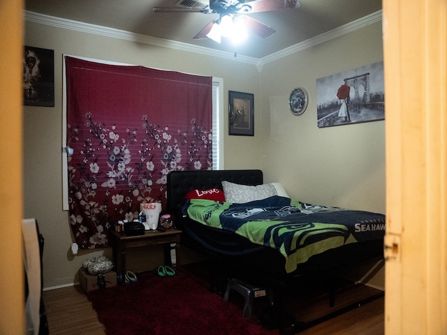 bedroom featuring wood-type flooring, ceiling fan, and crown molding