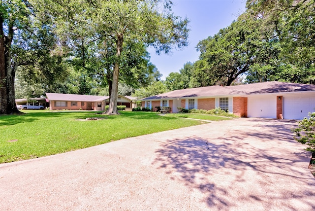 single story home featuring a front yard and a garage