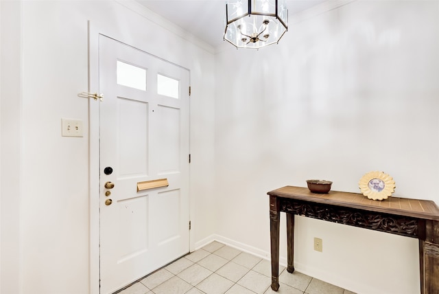 tiled entryway featuring ornamental molding