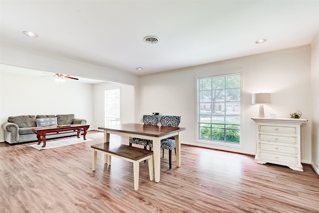 dining area featuring ceiling fan, crown molding, and light wood-type flooring