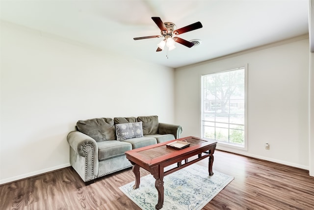 living room featuring ceiling fan, crown molding, and wood-type flooring