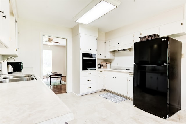 kitchen with sink, white cabinetry, ceiling fan, and black appliances