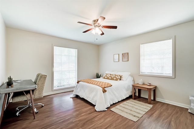 bedroom with ceiling fan and dark hardwood / wood-style flooring