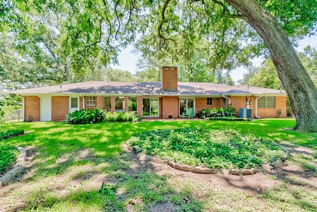 ranch-style home with a front yard and central AC