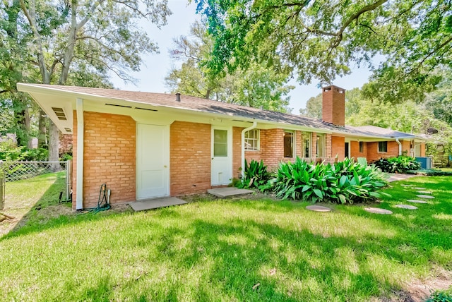 back of property featuring a lawn