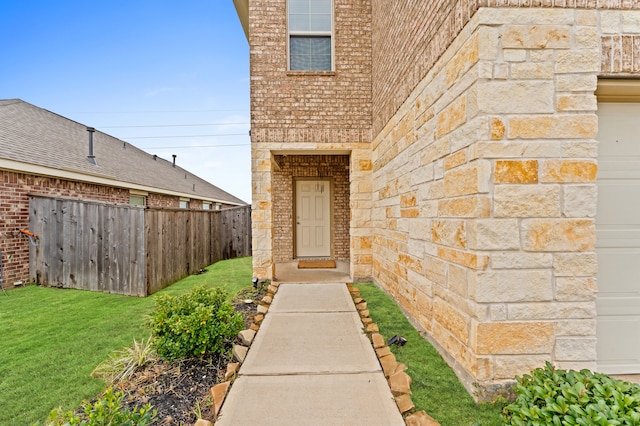 property entrance with a lawn