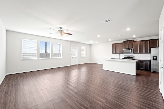 unfurnished living room with dark hardwood / wood-style floors, ceiling fan, and sink