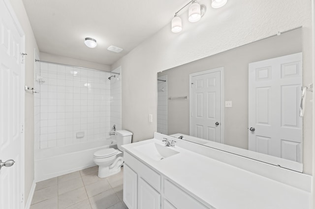 full bathroom featuring tile patterned flooring, vanity, tiled shower / bath combo, and toilet