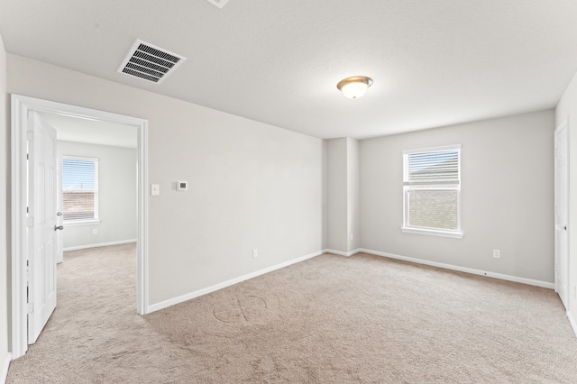 empty room with light colored carpet