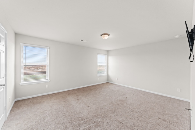 carpeted spare room with a healthy amount of sunlight