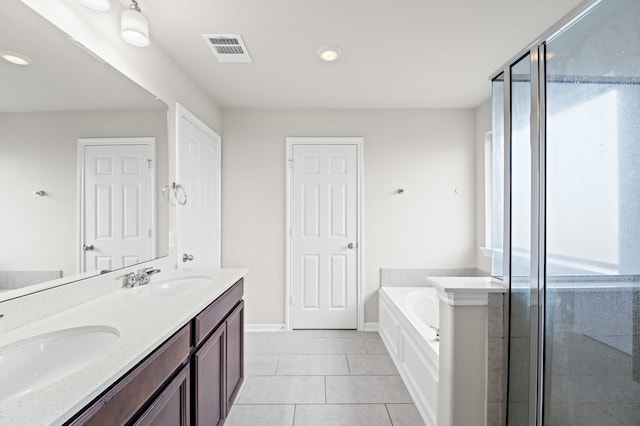 bathroom with tile patterned floors, vanity, and shower with separate bathtub