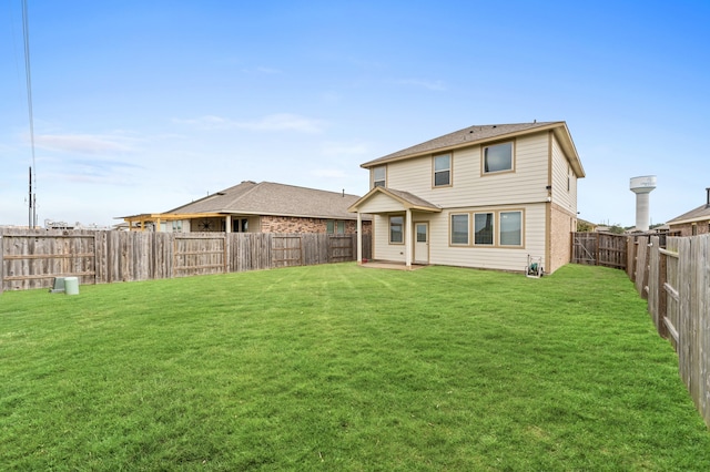 back of house with a lawn