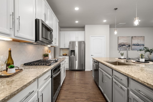 kitchen with dark hardwood / wood-style flooring, white cabinetry, sink, and appliances with stainless steel finishes