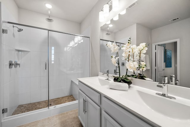 bathroom with tile patterned floors, vanity, and walk in shower