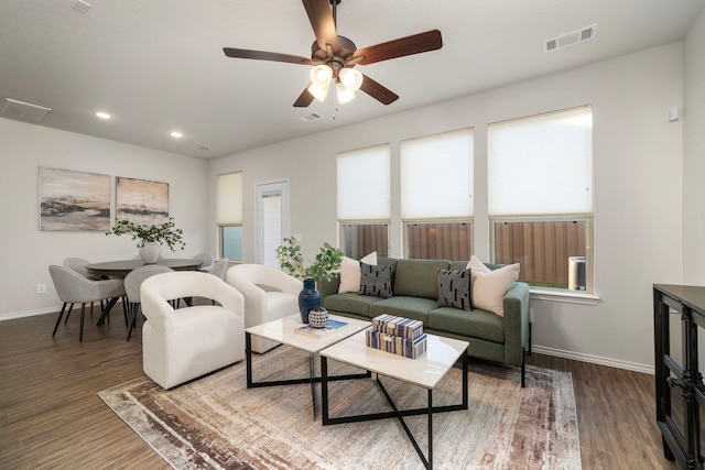 living room featuring hardwood / wood-style floors and ceiling fan