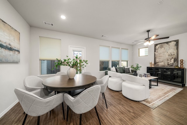 dining space featuring ceiling fan and dark wood-type flooring