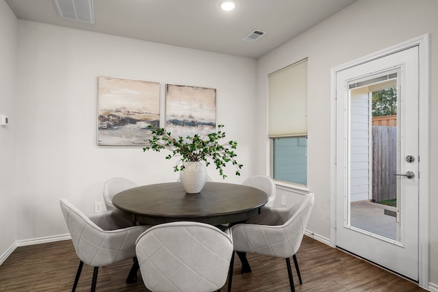 dining space with dark hardwood / wood-style floors