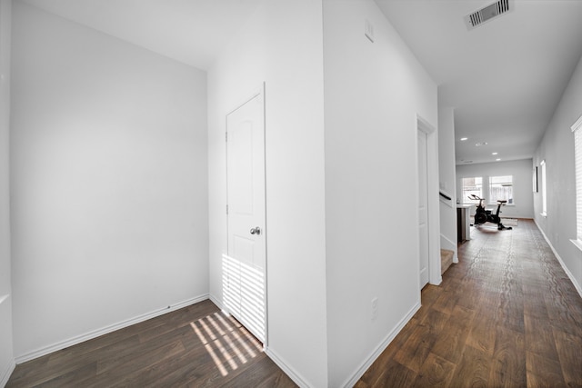 hallway with dark wood-type flooring