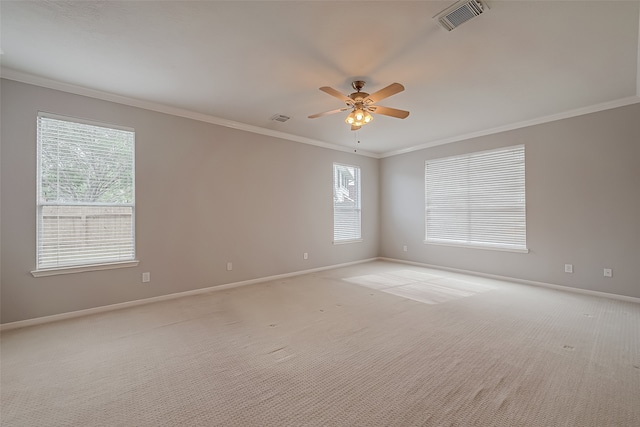 empty room with light carpet, ceiling fan, and ornamental molding