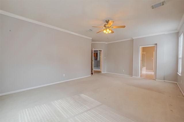 carpeted spare room featuring ceiling fan and crown molding