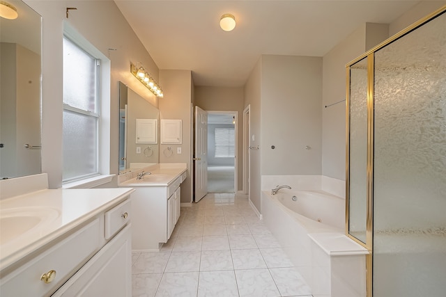 bathroom with plus walk in shower, vanity, and tile patterned flooring