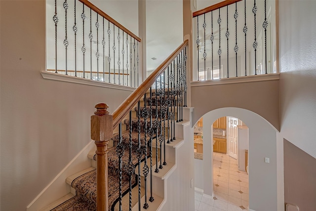 2519 Meadow Tree Ln, Spring, TX 77388 - stairway featuring arched walkways and tile patterned floors