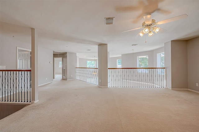 unfurnished room featuring ceiling fan and light colored carpet