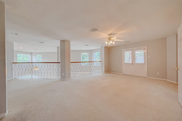 spare room with ceiling fan and light colored carpet