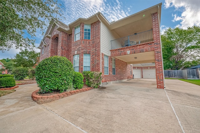 2519 Meadow Tree Ln, Spring, TX 77388 - view of front of house featuring concrete driveway, brick siding, a balcony, and an attached garage