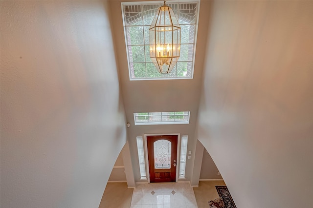 2519 Meadow Tree Ln, Spring, TX 77388 - entrance foyer featuring healthy amount of natural light, a chandelier, light tile patterned floors, and a towering ceiling
