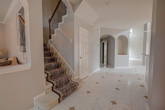 2519 Meadow Tree Ln, Spring, TX 77388 - entrance foyer featuring light tile patterned flooring, arched walkways, and stairway