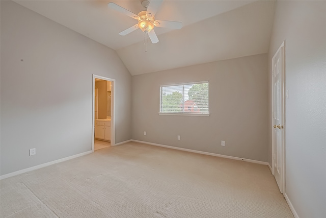 carpeted empty room with vaulted ceiling and ceiling fan