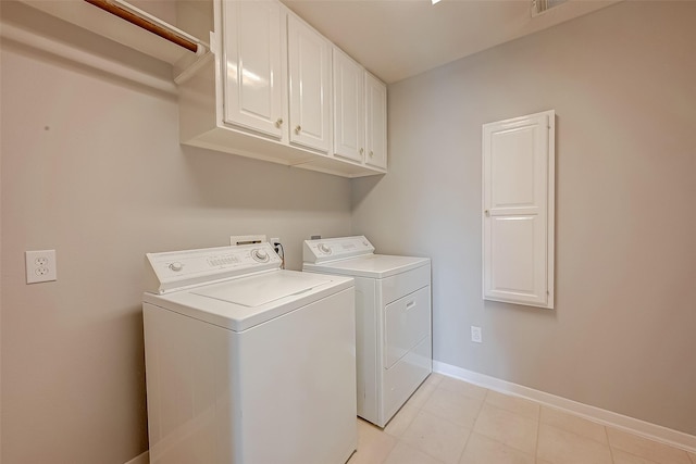 2519 Meadow Tree Ln, Spring, TX 77388 - washroom with cabinet space, separate washer and dryer, and light tile patterned floors
