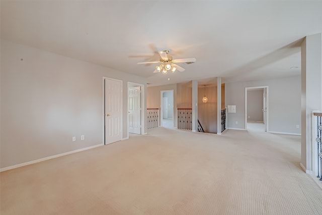 unfurnished living room featuring ceiling fan and light colored carpet