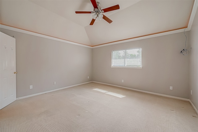 spare room with light carpet, vaulted ceiling, and ceiling fan