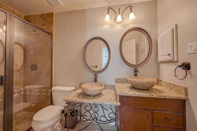 bathroom featuring vanity, toilet, and a shower with door