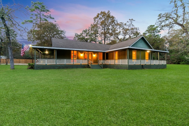 view of front of home with a lawn and a porch