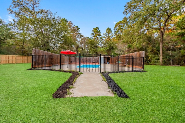 view of yard with a fenced in pool and a patio