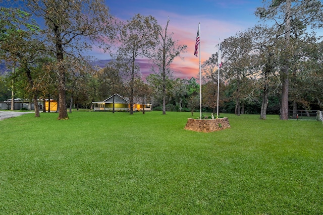 view of yard at dusk