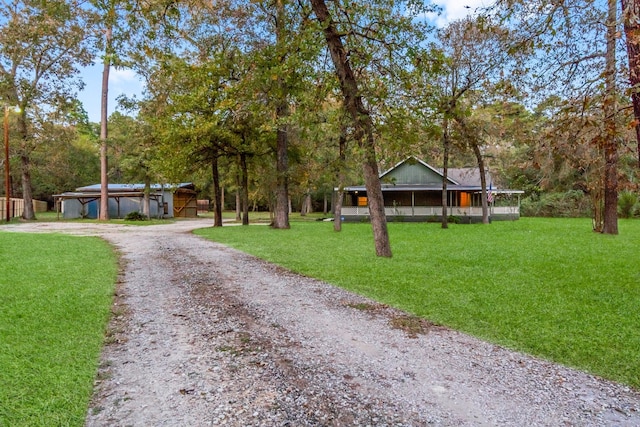 view of front of property with an outbuilding and a front lawn